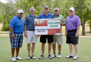 Adler showing off his win with the sign and his playing group